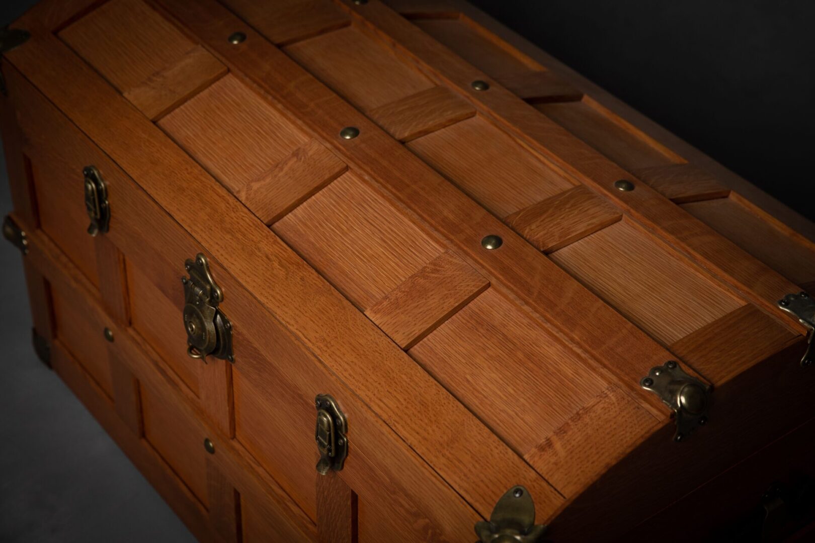 A wooden trunk with brass hardware and two drawers.