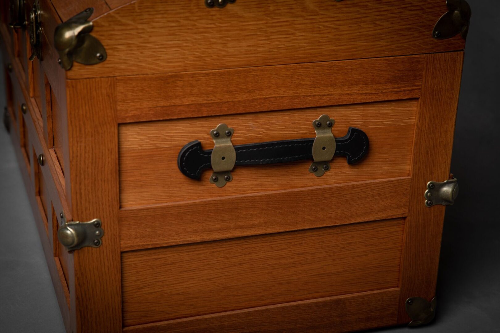 A close up of the drawer handle on an old chest.