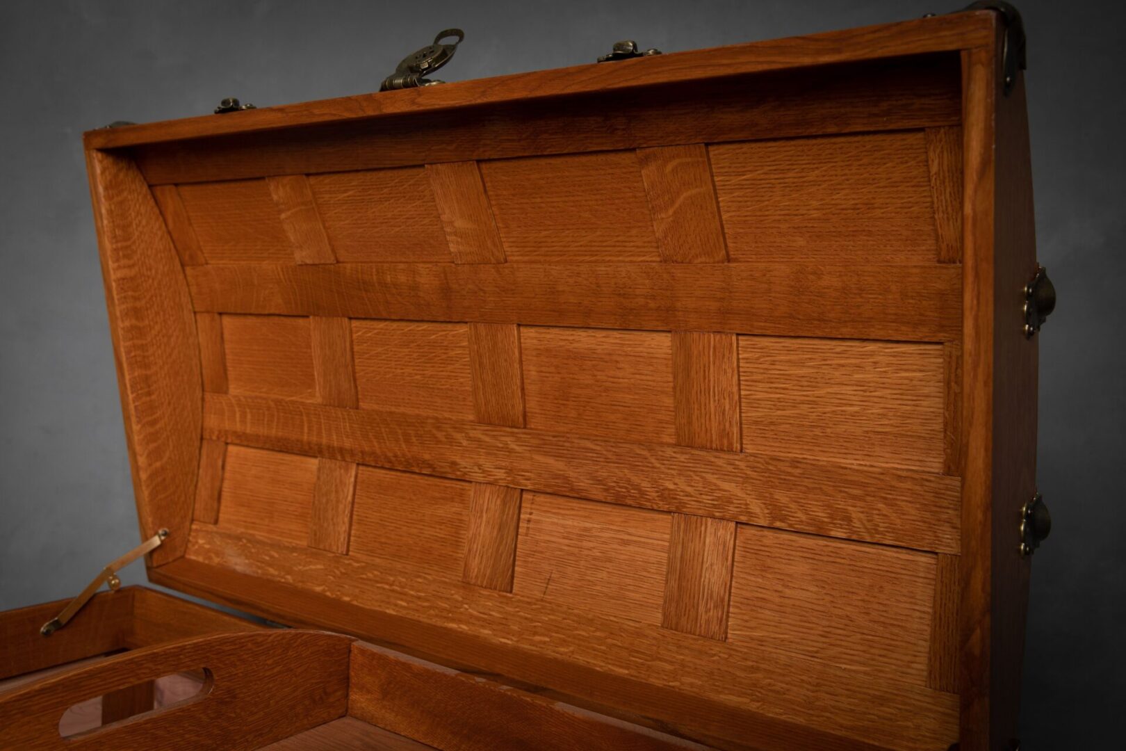 A wooden chest with many drawers on top of it.