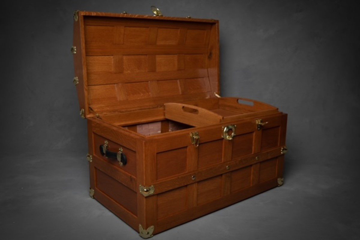 A wooden trunk with two compartments opened.