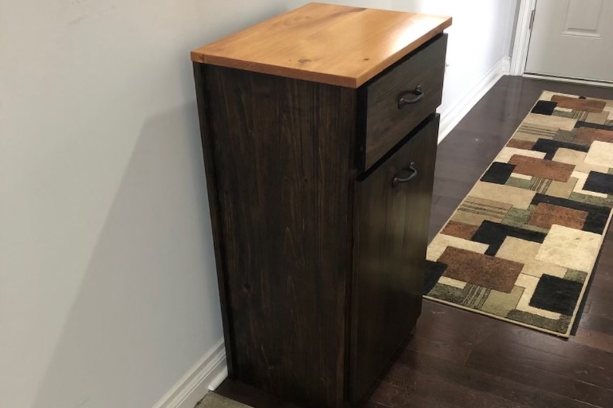 A wooden cabinet with two drawers and a wood top.