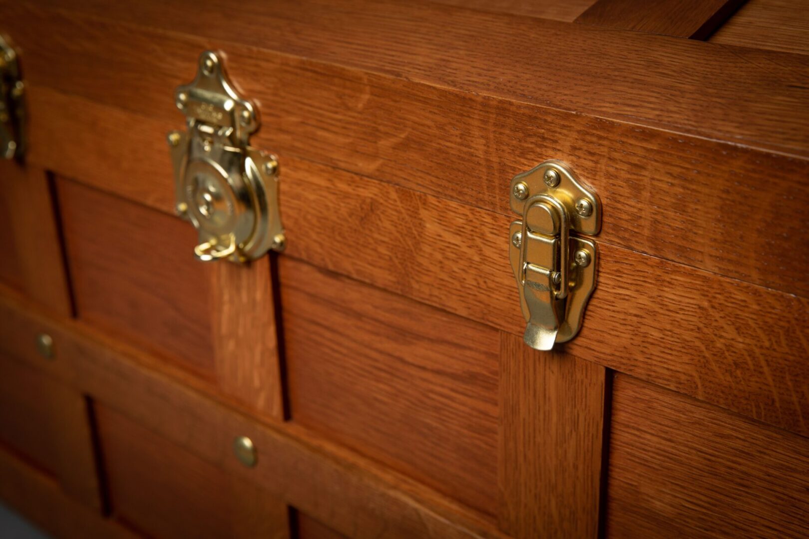 A close up of the handles on a wooden cabinet