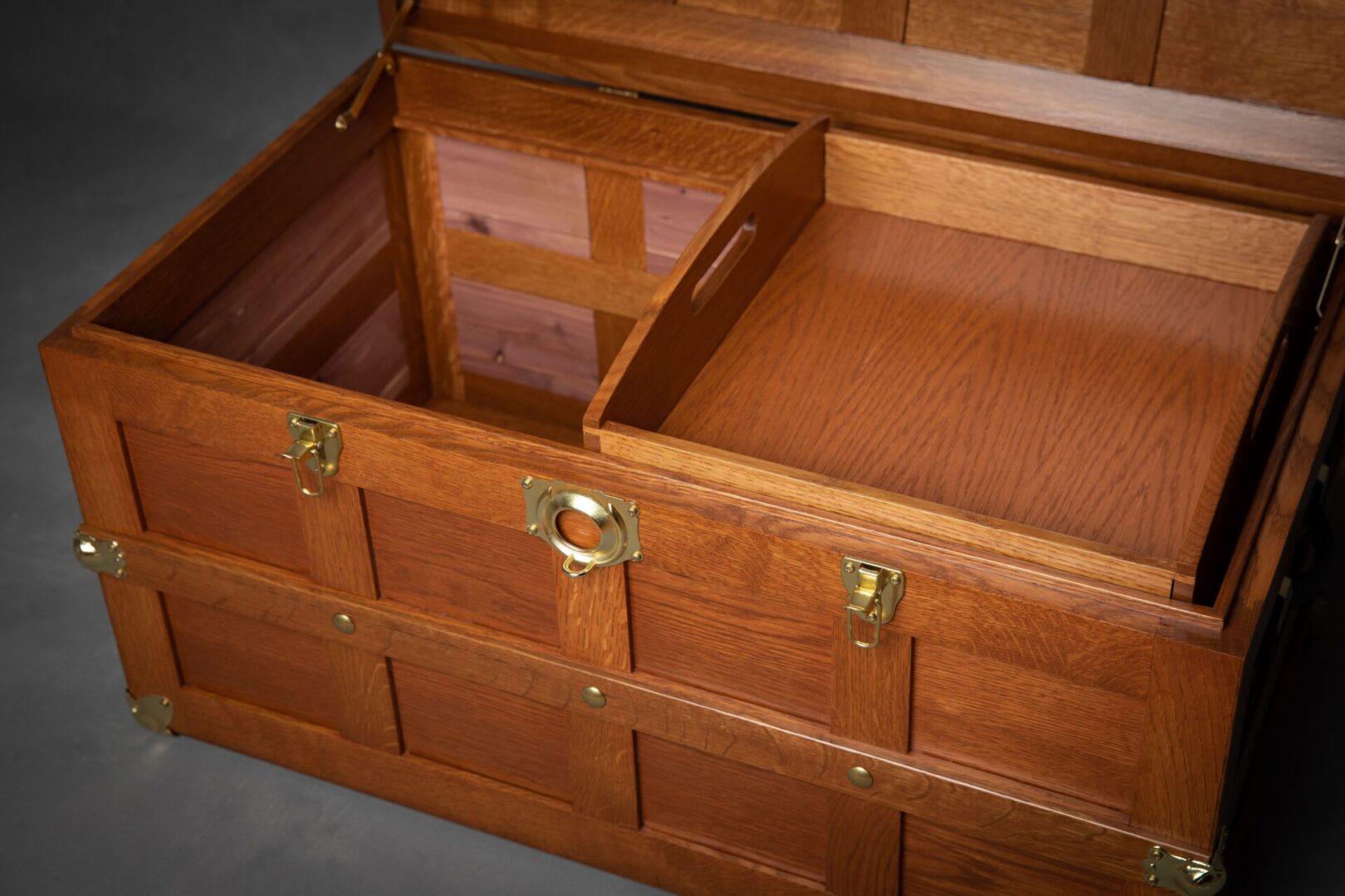 A wooden trunk with two compartments opened.