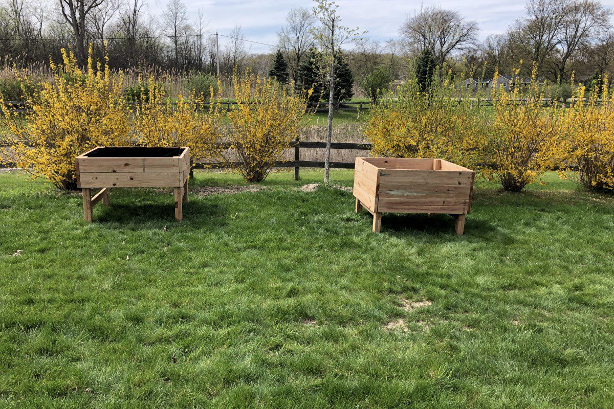 Two wooden planters in a field of grass