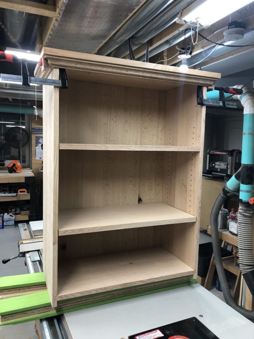 A bookshelf that is made of wood and has two shelves.