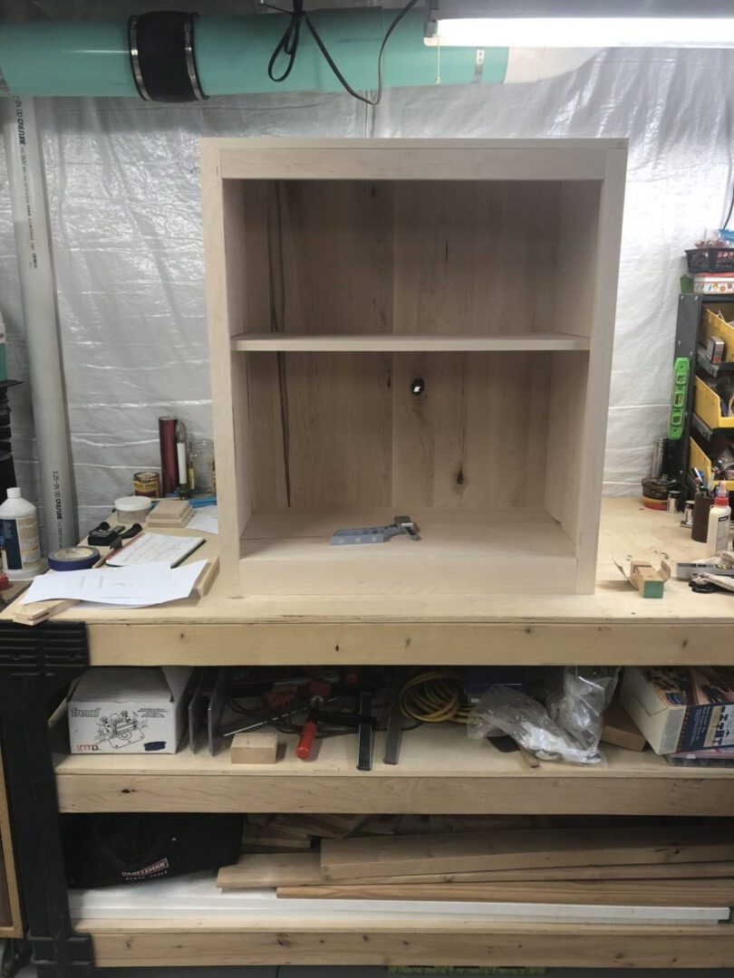 A wooden shelf sitting on top of a table.