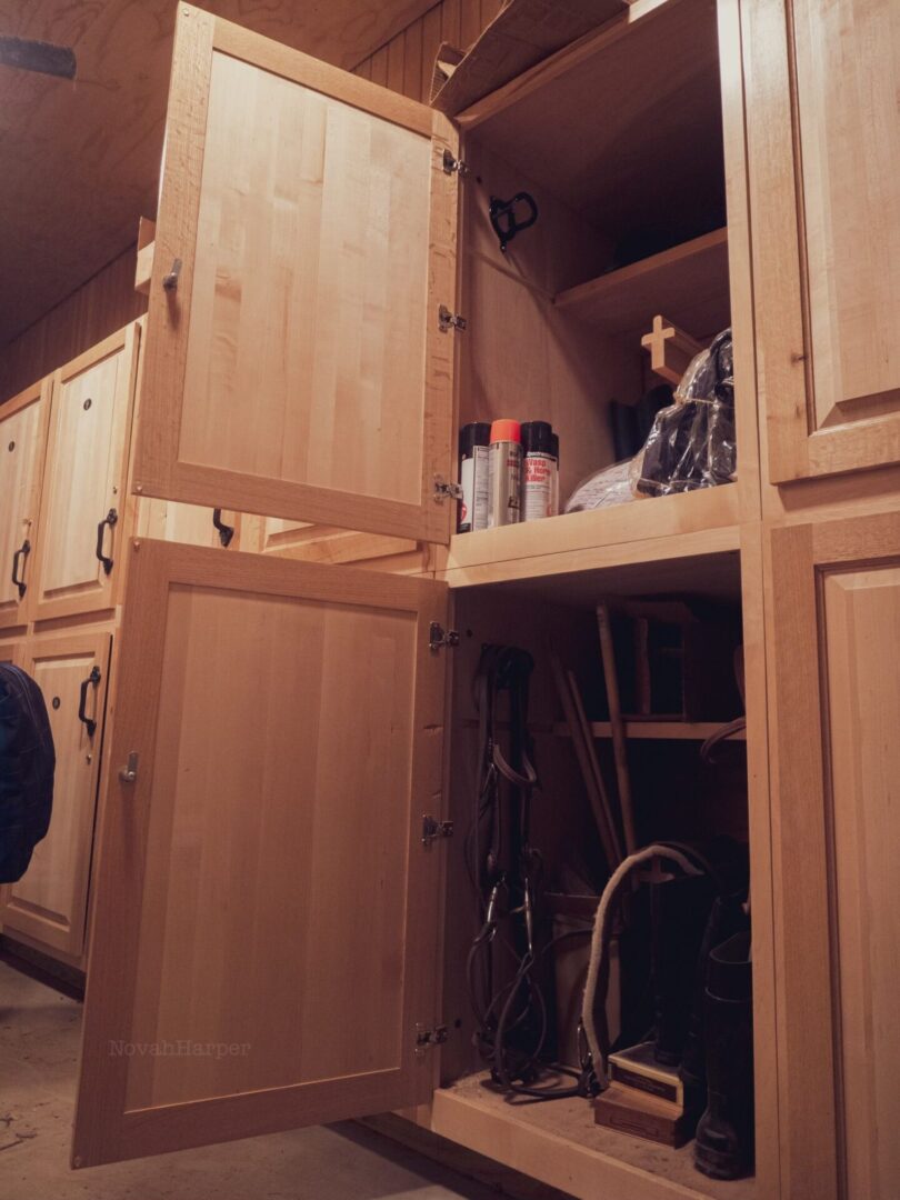 A wooden cabinet with many items inside of it