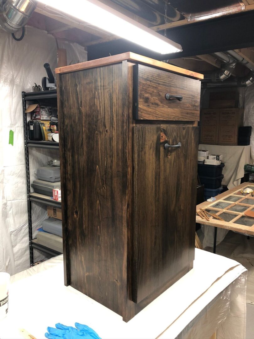 A wooden cabinet sitting in the middle of a room.