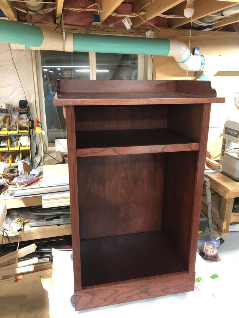 A wooden stand in the middle of a room.